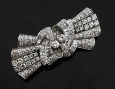 A 1930`s/1940`s platinum and gold, diamond set double clip brooch, of stylised ribbon bow design,