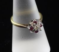 An 18ct gold, ruby and diamond set cluster ring, size P.