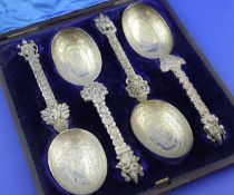 A cased set of four Victorian silver gilt spoons, in the Indian style, with engraved bowls, foliate