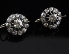 A pair of Edwardian gold and diamond cluster earrings.