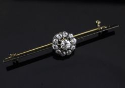 A gold and diamond cluster bar brooch, with central flowerhead motif, 2.5in.