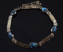 An early 20th century 9ct gold and turquoise set gate link bracelet, with safety chain, gross