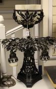An early 20th century French black painted and wrought iron table lamp, modelled as fruiting