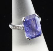 A white gold, sapphire and diamond dress ring, the emerald cut Sri Lankan sapphire weighing 12.