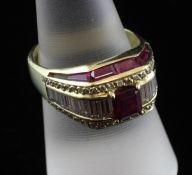 An 18ct gold, ruby and diamond dress ring, set with emerald cut ruby and graduated baguette cut