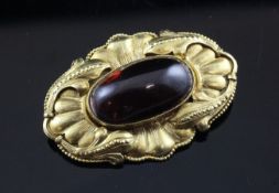 A late 19th/early 20th century continental gold and oval cabochon garnet set brooch, 1.5in.