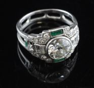 A French 1930`s Art Deco platinum, emerald and diamond cocktail ring, set with baguette and round