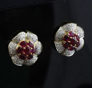A pair of gold, ruby and diamond flowerhead earrings.