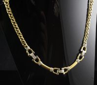An 18ct two colour gold curb link choker necklace with horseshoe shaped links set with diamond,