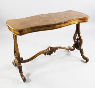 A Victorian burr walnut serpentine stretcher table, with pierced vase shaped panel ends and
