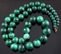 A single strand graduated malachite bead necklace, interspaced with small green glass beads, 24in.