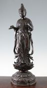 A large Japanese bronze figure of Kwannon, Meiji period, in standing pose holding a vase in her