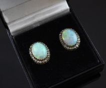 A pair of gold, white opal and diamond ear studs, with oval cut stones bordered with rose cut