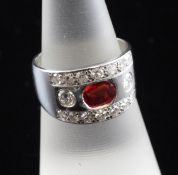A white gold, orange sapphire and diamond dress ring, with collet set oval cut sapphire weighing an