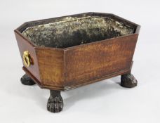 A Regency mahogany wine cooler, with tapering octagonal sides and brass ring handles, on hairy paw