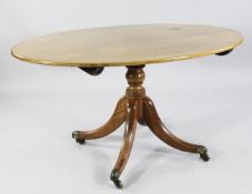 A Regency mahogany oval breakfast table, with turned central column, four downswept supports and