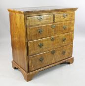 An 18th century walnut and featherbanded chest, of two short and three long graduated drawers, on