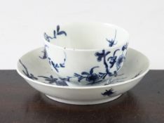 A Worcester Prunus Root pattern teabowl and saucer, c.1760, painted in underglaze blue, open