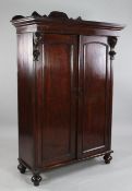 A Victorian Anglo Indian teak two door cabinet, fitted a pair of panelled doors with floral carved