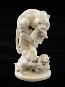 A Japanese ivory group of tigers, early 20th century, with the figure of a tigress grasping a