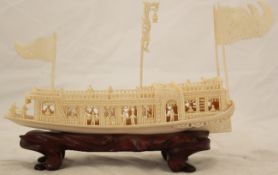 A Chinese ivory model of a pleasure boat, early 20th century, carved with openwork figures,