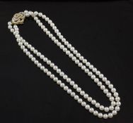 A double strand cultured pearl choker necklace with pierced 18ct gold and diamond set clasp, 14in.