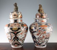 A pair of Japanese Arita ovoid jars and covers, 18th century, each painted with phoenixes perched