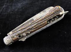 A Victorian horn handled multi-tool pocket knife, with seven folding blades including a corkscrew,