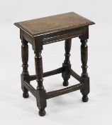 An 18th century oak joint stool, on turned supports united by stretcher, W.1ft 6.5in.
