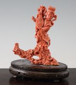 A Chinese coral figure of a female immortal holding a pipa, mid 20th century, with flowing robes