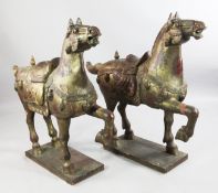 A pair of large carved and gilt Chinese style model horses, each on a rectangular plinth base, W.