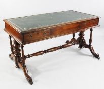A Victorian style mahogany writing table, with gilt tooled green leather skiver and two frieze