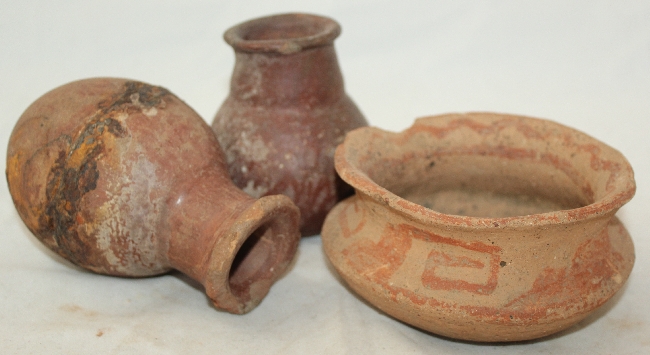 Three pre-Columbian pottery vessels, the first an Aztec bowl with red slip keywork decoration, 12cm