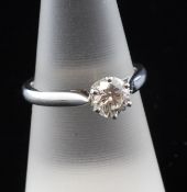 A platinum set solitaire diamond ring, the round brilliant cut stone weighing approximately 1.03ct,
