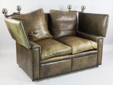 A brown leather and brass studded two seater Knole settee, with cushions and chrome plated finials