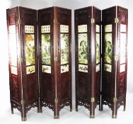 A pair of Chinese rosewood four fold screens, inset with painted alabaster panels within a pierced