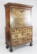 An early 18th century walnut escritoire, with secret cushion frieze drawer and fall front revealing