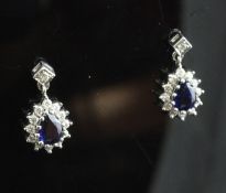 A pair of 18ct white gold sapphire and diamond cluster drop ear studs.