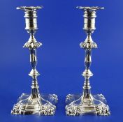 A pair of George V 18th century style silver candlesticks, with turned knopped stems, on square