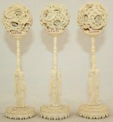 Three Chinese ivory concentric puzzle balls and stands, early 20th century, each ball supported by