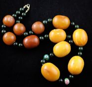 A single strand graduated amber, bakelite and nephrite bead necklace, with gilt metal clasp and two