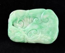 A Chinese jadeite plaque, carved in low relief with a phoenix grasping a branch with berries, the