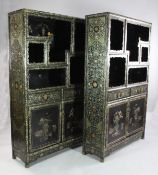 A pair of Chinese black lacquer side cabinets, decorated with gilt and polychrome floral motifs and