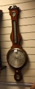 A late Regency strung mahogany wheel barometer, with silvered hygrometer, thermometer, dial and