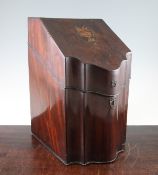 A George III mahogany knife box, the hinged lid with oval marquetry central reserve and serpentine