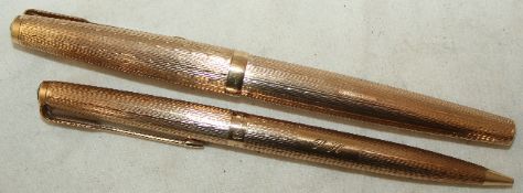 A 1960`s engine turned 9ct gold Parker 61 fountain pen and pencil set, with engraved initials, pen