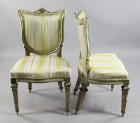 A pair of Italian neo-classical cream and gilt side chairs, upholstered in a yellow cream striped