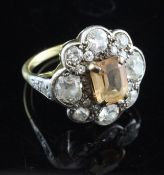 An early 20th century gold, pink topaz and diamond cluster ring, set with emerald cut topaz and