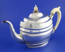 A George III Irish provincial silver oval teapot by John Whelpley, Cork, engraved with foliate