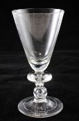 A large heavy baluster goblet, c.1700, the round funnel bowl above teared angular and basal knops,